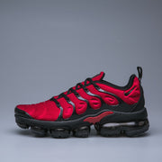 Side profile of a red and black Nike TN sneaker.