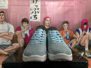 Front view of grey basketball shoes with blue laces