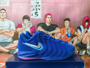 Side profile of a royal blue Nike Kobe basketball shoe with a pink-tinted outsole.
