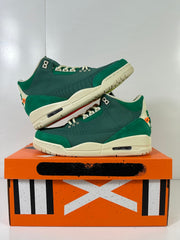Pair of green retro high-top sneakers arranged on an orange shoebox.