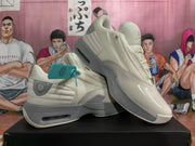 Beige sneakers displayed at an angle, showing the side panels and sculpted soles