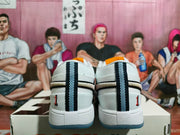 Rear view of white sneakers showing dark striped heel details and small number 1 accents.