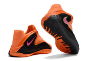 Orange and black Nike Giannis Immortality 7 shoes showing heel and outsole details