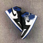 Overhead view of a pair of black, white, and blue high-top sneakers with an additional blue lace set in a clear packet.