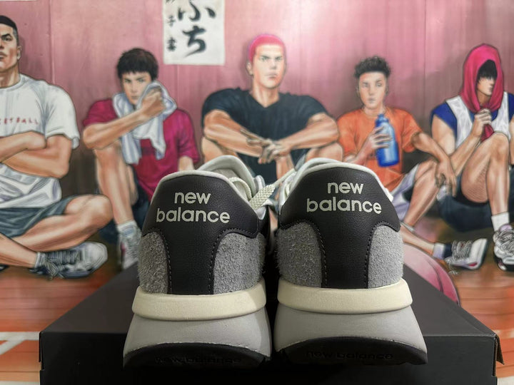 Pair of grey New Balance U370 sneakers shown from the heel