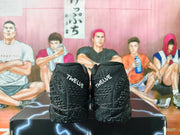 Rear view of black basketball shoes with “TWELVE” text on the heels.
