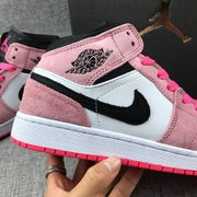 Close-up of the pink upper, Air Jordan wing logo, black Swoosh and white side panel.