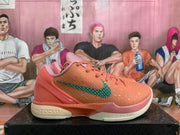 Profile view highlighting the teal side logo, textured upper, and light-colored sole.