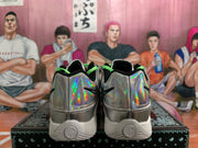 Rear view of Nike sneakers with iridescent silver heels, black accents, and white soles.