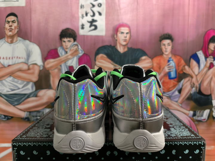 Rear view of Nike sneakers with iridescent silver heels, black accents, and white soles.