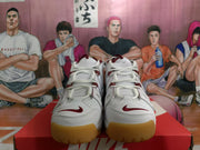 Front view of white Nike sneakers showing burgundy laces and accents with translucent gum-colored toe outsoles.
