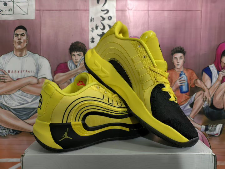 Pair of yellow and black basketball sneakers displayed at an angle on a box.