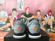 Rear view of grey Jordan low-top sneakers with orange heel branding