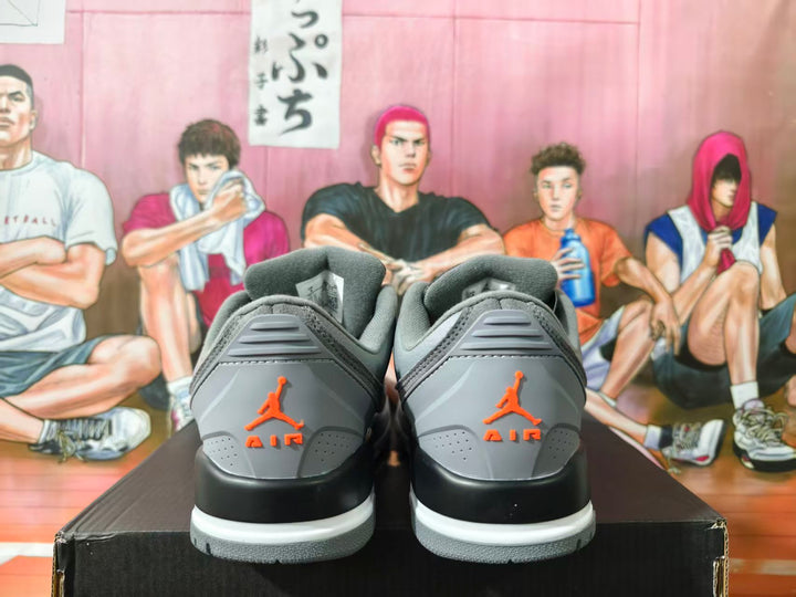 Rear view of grey Jordan low-top sneakers with orange heel branding