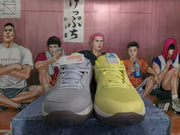 Front view of mismatched Nike sneakers with a light gray shoe beside a yellow shoe, both featuring mesh uppers and lace-up closures.