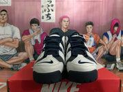 Front view of white and dark navy Nike basketball shoes with lace-up closures.