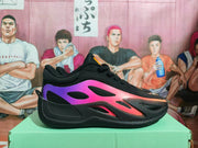 Side profile highlighting the purple-to-pink panel on a black Jordan sneaker