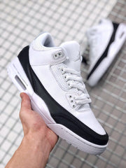 Front three-quarter view showing the white toe box, black mudguard, and lace system.