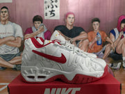 Side view of a white Nike basketball sneaker with a red Swoosh, layered panels, and a sculpted white-and-red outsole.