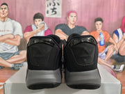 Rear view of the black and gray basketball sneakers showing padded heel panels, glossy heel details, and contrasting midsoles.