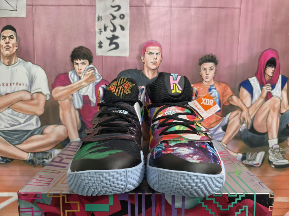 Front view of colorful Nike basketball sneakers with black laces, graphic uppers, and textured light blue-gray outsoles.