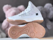 Side and outsole views showing the gum-colored patterned tread