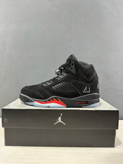Single black Air Jordan 5 sneaker in side profile with red accents, side mesh panel, and number 23 detail.