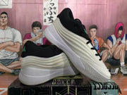 Angled view showing the layered side panels, light-colored midsole, and textured outsole.