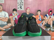 Front view showing the black uppers, green accents, patterned laces, and Nike logos.