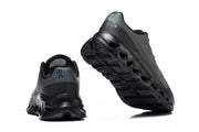 Rear and outsole views of the charcoal On Cloudtilt Remix sneakers.
