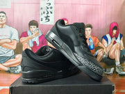 Black low-top sneakers displayed at an angle, showing the patterned toe overlay and heel Air unit.