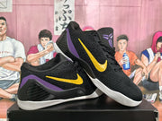Angled view of a pair of black Nike basketball sneakers with yellow Swooshes, purple accents, and white outsoles.