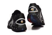 Rear and outsole views of black Nike sneakers with blue and red outsole details