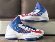 Side profile of the Nike high-top sneaker with blue collar and red detailing.