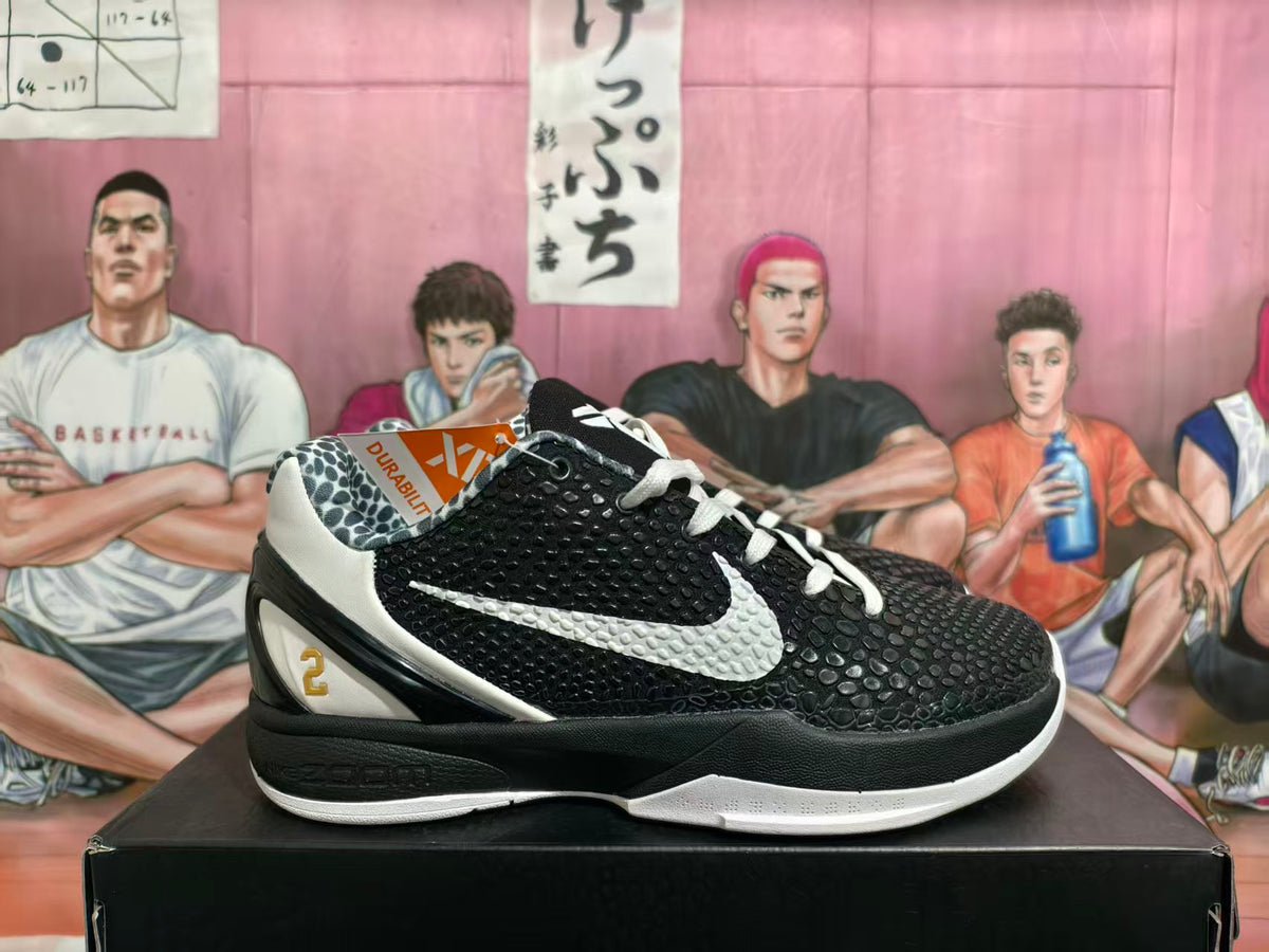 Side view of black and white basketball shoe with textured upper, white Swoosh, and gold number 2 detail.