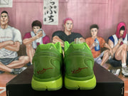 Rear view of the green sneakers showing layered heel panels and red script detailing.