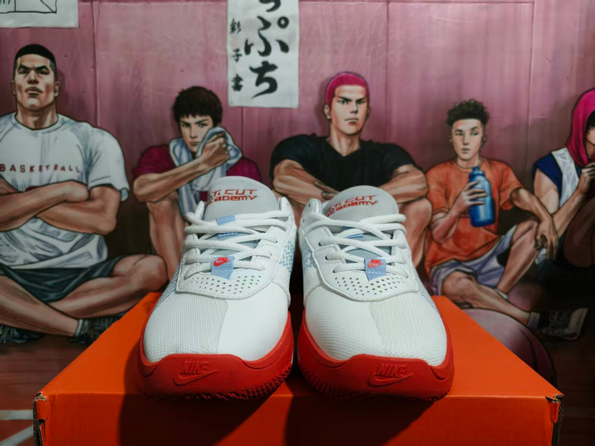Front view of white and red Nike KD basketball sneakers displayed on an orange shoebox.