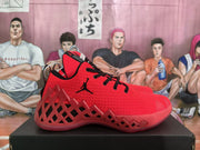 Side profile showing the textured red upper, black laces, Jumpman branding, and geometric side structure.
