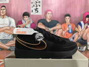 Side view of a black Nike Sabrina basketball shoe with gold-tone Swoosh trim.