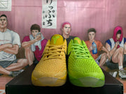 Front view of the yellow and green Nike basketball shoes, showing the textured uppers and laces.