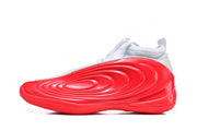Side profile of a white and red sneaker with raised oval detailing.