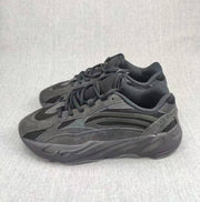 Pair of charcoal and gray lace-up sneakers shown from a three-quarter angle.