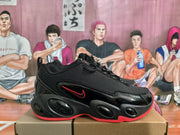 Side profile showing the black upper, red Nike logo accent, and rounded sculpted outsole details.