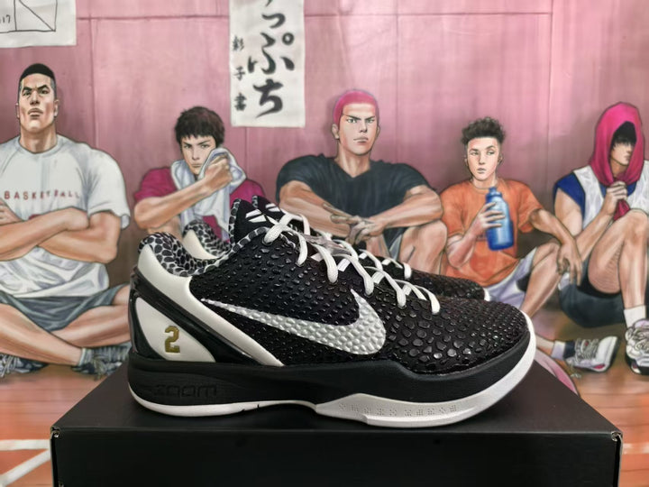 Pair of black and white basketball sneakers shown from the side, featuring textured uppers, white side panels, and a black box.
