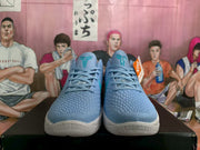 Front view of blue Nike Kobe basketball shoes with teal details