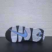 Underside of a sneaker showing the black and white outsole and Nike Swoosh.