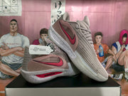 Angled view showing the pink Nike Swoosh, layered side panels, and visible ZoomX branding.