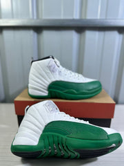 Side and outsole views of a white and green high-top Jordan sneaker.