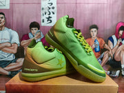 Angled view of the green shoes showing the star side detail and textured upper.