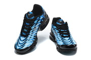 Front views of the pair of blue patterned Nike Air Max Plus VII sneakers.